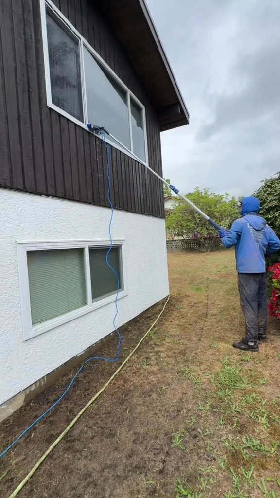 Second-storey windows cleaned from the lawn with a water-fed extension pole