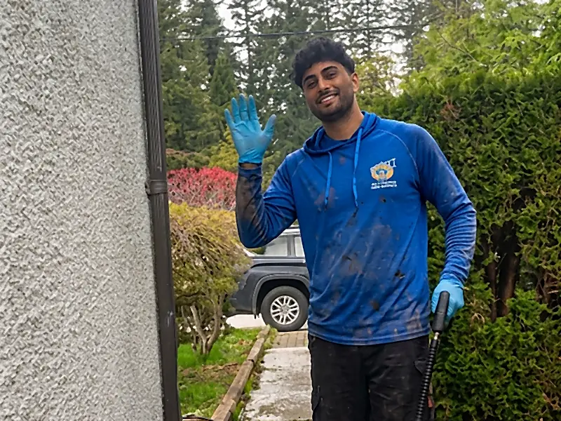 All Canadian Home Services technician with a pressure washing wand at a Surrey BC home